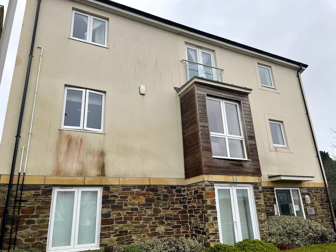 Rendered apartment building with fascias, soffits and timber-clad bay, Devon — Brixham